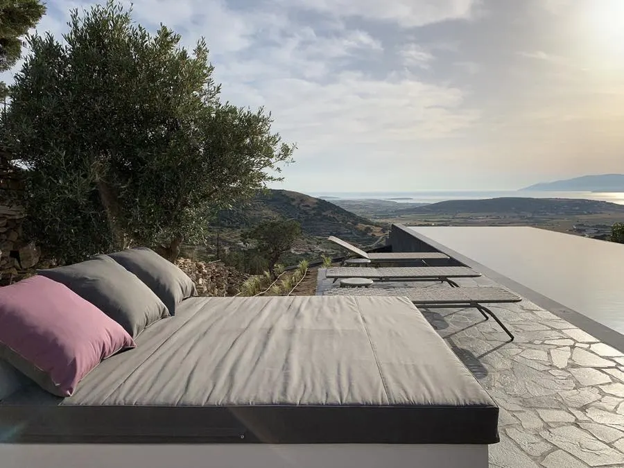 Loungers on the terrace beside the infinity pool